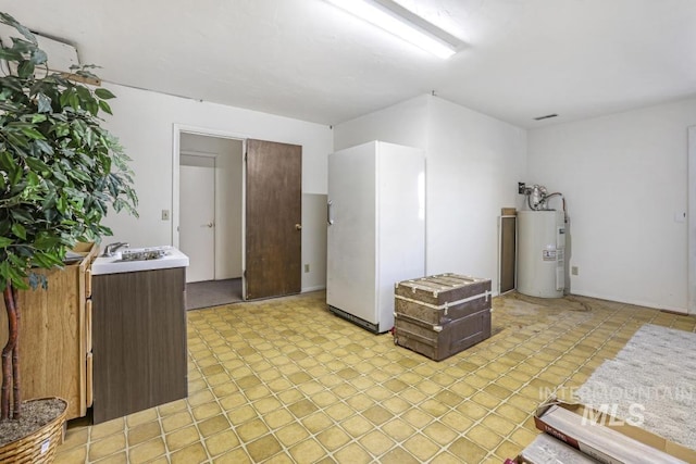111 Main, Hagerman, ID 83332 - unfurnished room with electric water heater and a sink