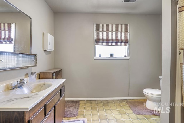 111 Main, Hagerman, ID 83332 - bathroom featuring toilet, vanity, baseboards, and tile patterned floors