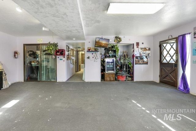 111 Main, Hagerman, ID 83332 - unfurnished living room with a textured ceiling and carpet floors