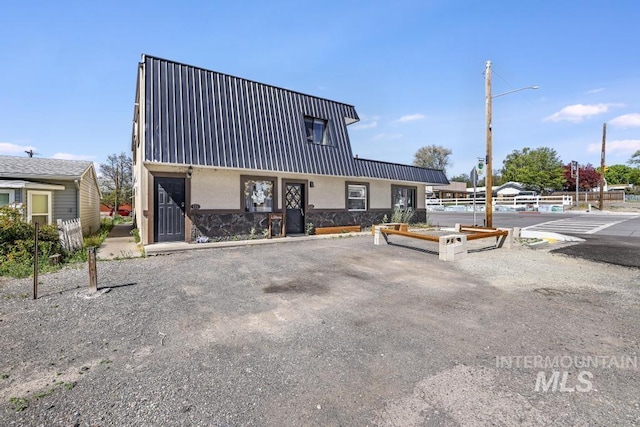 111 Main, Hagerman, ID 83332 - view of front facade featuring stucco siding, stone siding, and metal roof