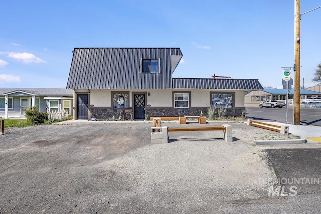 111 Main, Hagerman, ID 83332 - view of property featuring stucco siding, stone siding, and metal roof