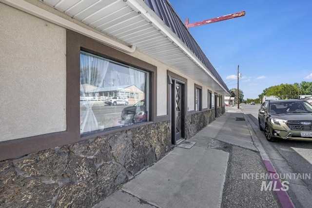 111 Main, Hagerman, ID 83332 - view of property exterior with stone siding, stucco siding, and metal roof