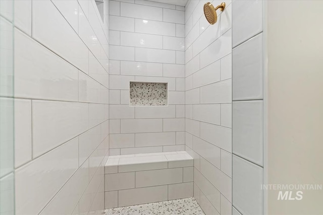 bathroom with tiled shower
