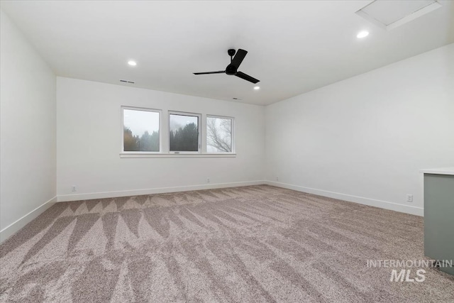 carpeted spare room featuring baseboards, visible vents, recessed lighting, and a ceiling fan