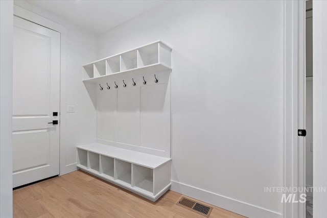mudroom featuring baseboards, visible vents, and light wood-style flooring