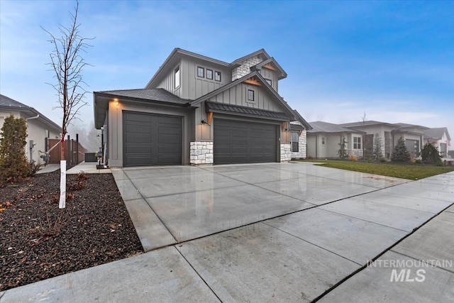 view of front of house with stone siding, board and batten siding, driveway, and an attached garage