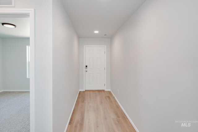 corridor with light wood-type flooring