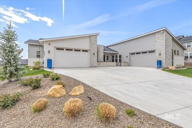 2391 S Trapper Pl, Boise, ID 83716 - view of front of property featuring an attached garage, driveway, and stone siding