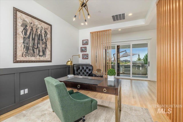 2391 S Trapper Pl, Boise, ID 83716 - home office with recessed lighting, visible vents, wood finished floors, and a wainscoted wall