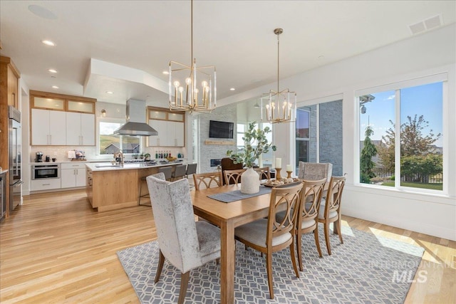2391 S Trapper Pl, Boise, ID 83716 - dining room with a notable chandelier, light wood-style floors, recessed lighting, lofted ceiling, and visible vents