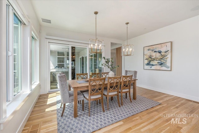 2391 S Trapper Pl, Boise, ID 83716 - dining area with light wood-style floors, baseboards, a notable chandelier, and visible vents