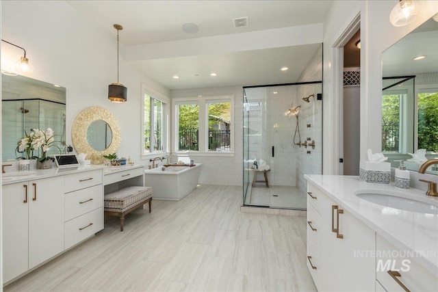 2391 S Trapper Pl, Boise, ID 83716 - full bath featuring a sink, a freestanding tub, a stall shower, and a wealth of natural light