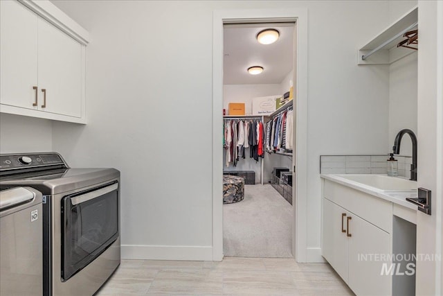 2391 S Trapper Pl, Boise, ID 83716 - washroom with cabinet space, independent washer and dryer, baseboards, and a sink