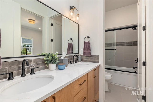 2391 S Trapper Pl, Boise, ID 83716 - bathroom with double vanity, a sink, enclosed tub / shower combo, and toilet