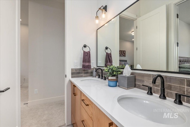 2391 S Trapper Pl, Boise, ID 83716 - bathroom with a sink, baseboards, tasteful backsplash, and double vanity