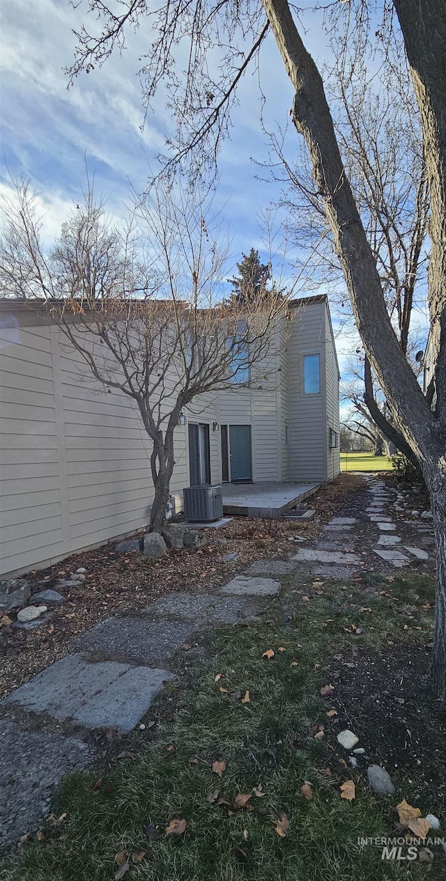rear view of property featuring cooling unit and a patio area