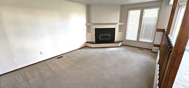 unfurnished living room with carpet flooring