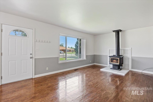 1341 N Fillmore, Jerome, ID 83338 - unfurnished living room with a wood stove and wood finished floors
