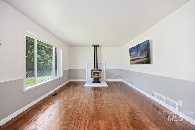 1341 N Fillmore, Jerome, ID 83338 - unfurnished living room featuring wood finished floors and a wood stove