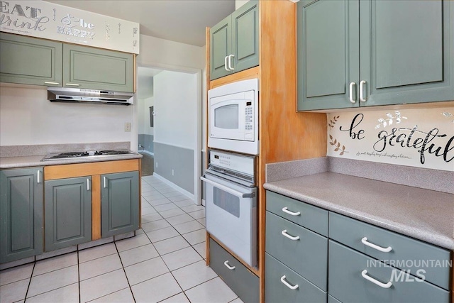 1341 N Fillmore, Jerome, ID 83338 - kitchen featuring white appliances, light tile patterned floors, light countertops, and under cabinet range hood