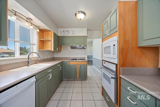 1341 N Fillmore, Jerome, ID 83338 - kitchen with white appliances, green cabinetry, under cabinet range hood, light tile patterned floors, and light countertops