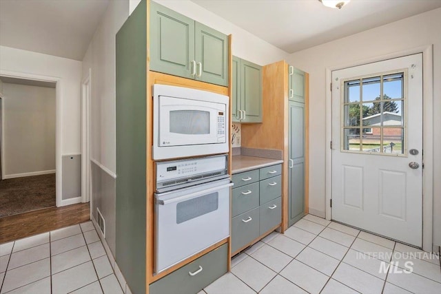 1341 N Fillmore, Jerome, ID 83338 - kitchen with white appliances, green cabinetry, light tile patterned flooring, and light countertops