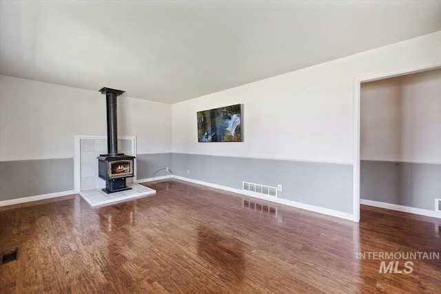 1341 N Fillmore, Jerome, ID 83338 - unfurnished living room with a wood stove and wood finished floors