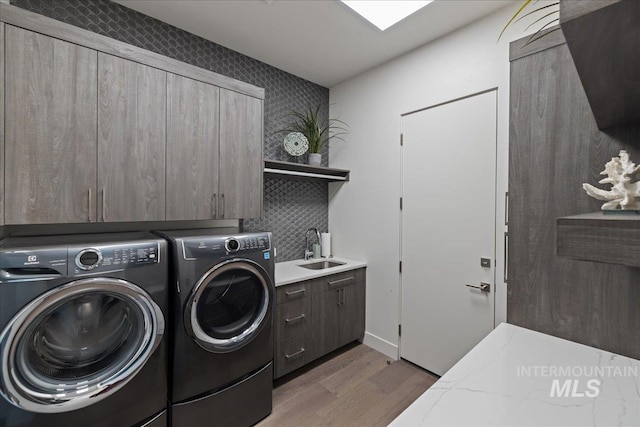 1865 E Lone Shore Ln, Eagle, ID 83616 - laundry area featuring cabinet space, a sink, washer and clothes dryer, and wood finished floors