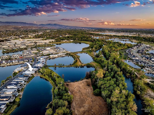 1865 E Lone Shore Ln, Eagle, ID 83616 - aerial view at dusk featuring a water and mountain view