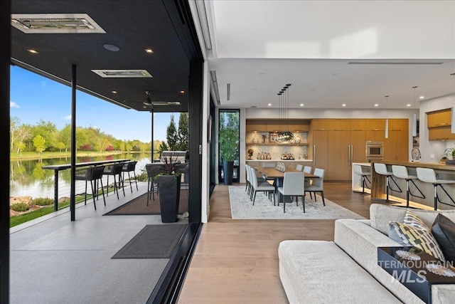 1865 E Lone Shore Ln, Eagle, ID 83616 - living room featuring light wood-style floors, a water view, visible vents, and expansive windows