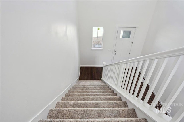 staircase featuring baseboards