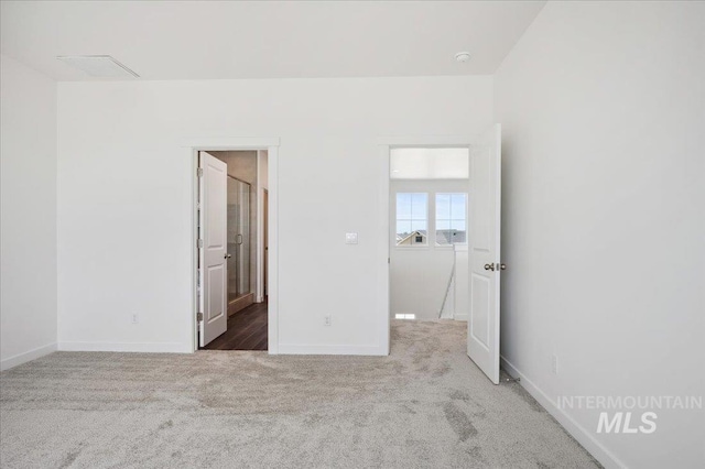 unfurnished bedroom featuring carpet floors and baseboards
