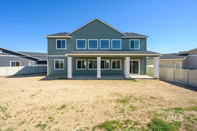 rear view of house featuring a patio area and a fenced backyard