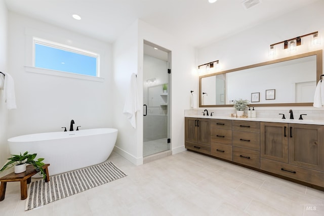12507 S Lenora Pl, Nampa, ID 83686 - full bath featuring a freestanding tub, a shower stall, a sink, visible vents, and double vanity