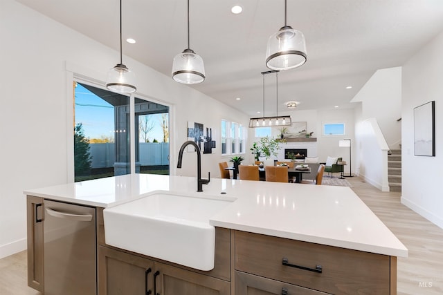 12507 S Lenora Pl, Nampa, ID 83686 - kitchen with light countertops, a sink, stainless steel dishwasher, and open floor plan