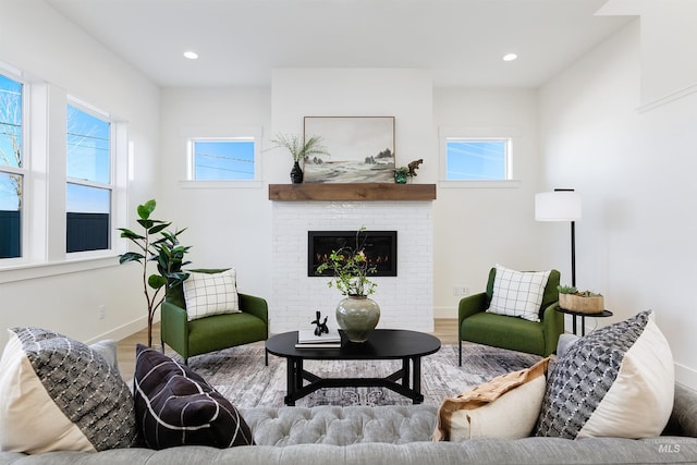 12507 S Lenora Pl, Nampa, ID 83686 - living area with a brick fireplace, a wealth of natural light, baseboards, and wood finished floors