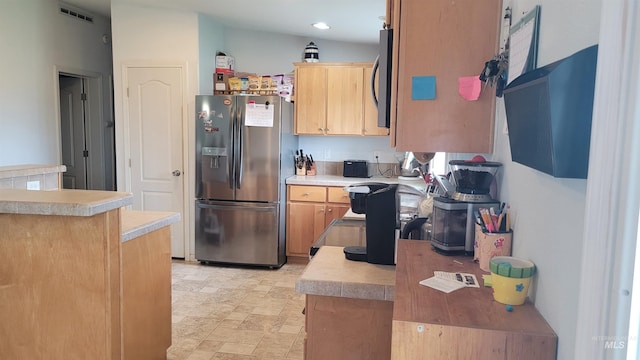 1455 S 2190 E, Malta, ID 83342 - kitchen featuring appliances with stainless steel finishes, light countertops, recessed lighting, light brown cabinetry, and stone finish floors