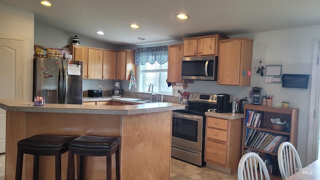 1455 S 2190 E, Malta, ID 83342 - kitchen featuring appliances with stainless steel finishes, a sink, recessed lighting, a kitchen breakfast bar, and light countertops