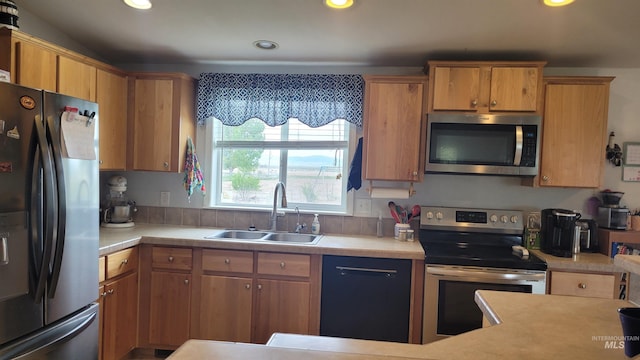 1455 S 2190 E, Malta, ID 83342 - kitchen featuring appliances with stainless steel finishes, a sink, light countertops, recessed lighting, and brown cabinets
