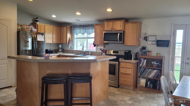 1455 S 2190 E, Malta, ID 83342 - kitchen with stainless steel appliances, recessed lighting, a kitchen island, light stone finish flooring, and a sink
