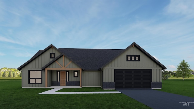 view of front of home with a front yard and a garage