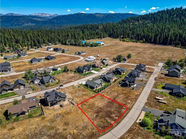 birds eye view of property with a mountain view