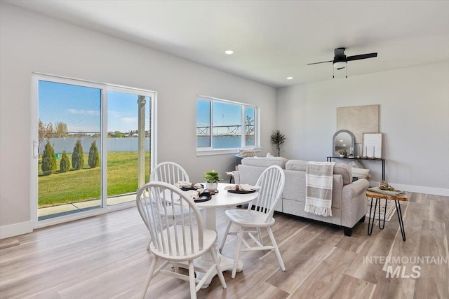 dining room featuring baseboards, recessed lighting, a ceiling fan, and light wood-style floors