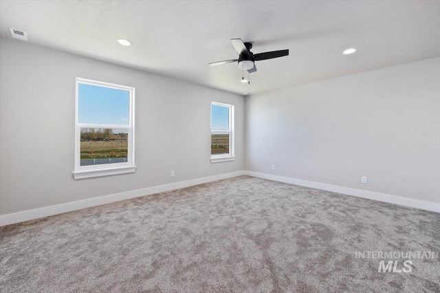 carpeted spare room with visible vents, a ceiling fan, recessed lighting, and baseboards