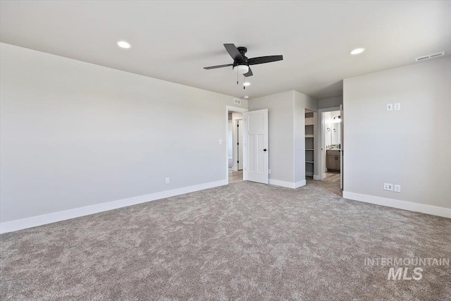 unfurnished bedroom featuring recessed lighting, ensuite bath, carpet flooring, baseboards, and visible vents