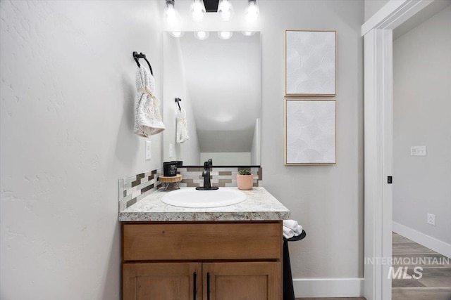 bathroom with vanity and baseboards