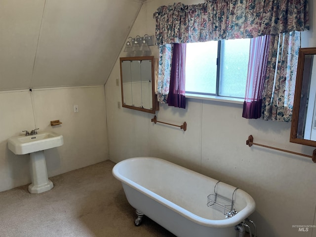 full bath with a soaking tub and vaulted ceiling