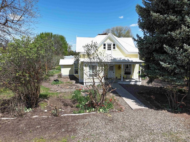 view of front facade featuring a porch and metal roof
