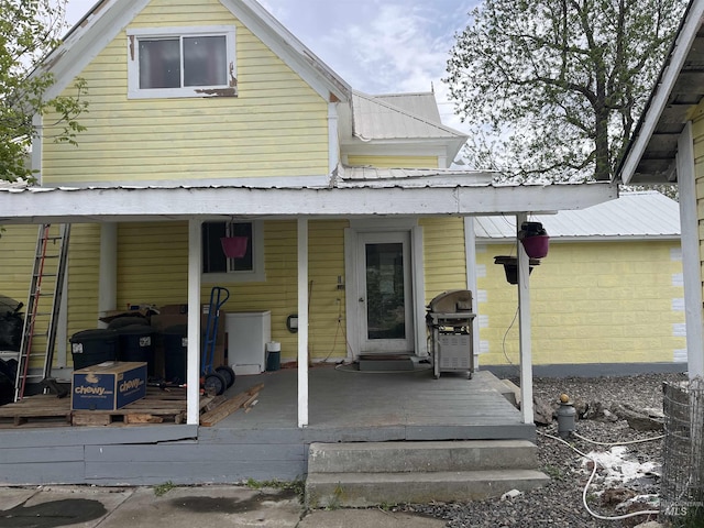 rear view of house featuring metal roof