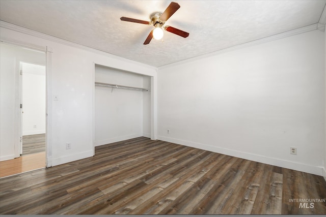 unfurnished bedroom featuring wood finished floors, baseboards, ornamental molding, a closet, and a textured ceiling